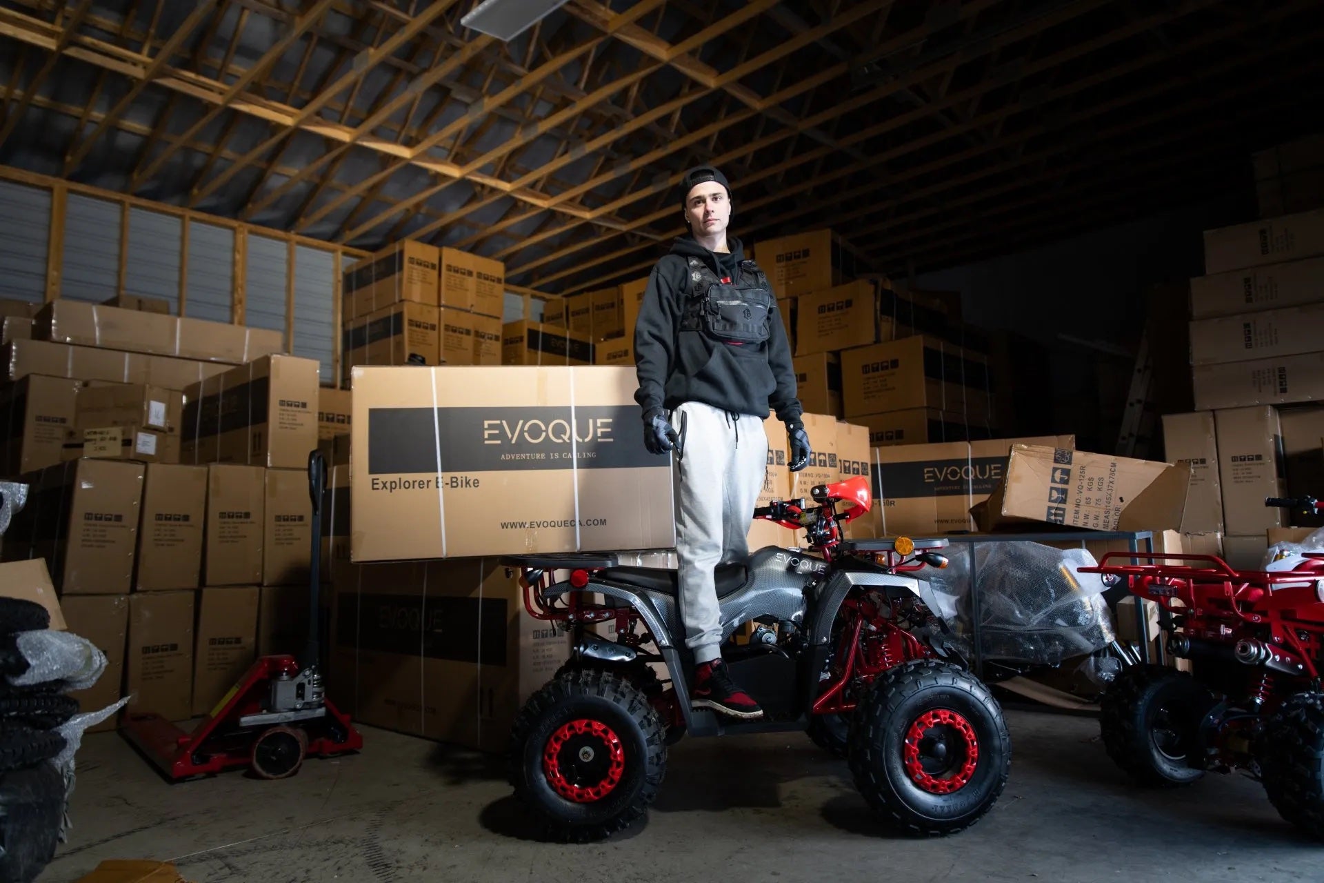 a man standing on a quad bike in a warehouse